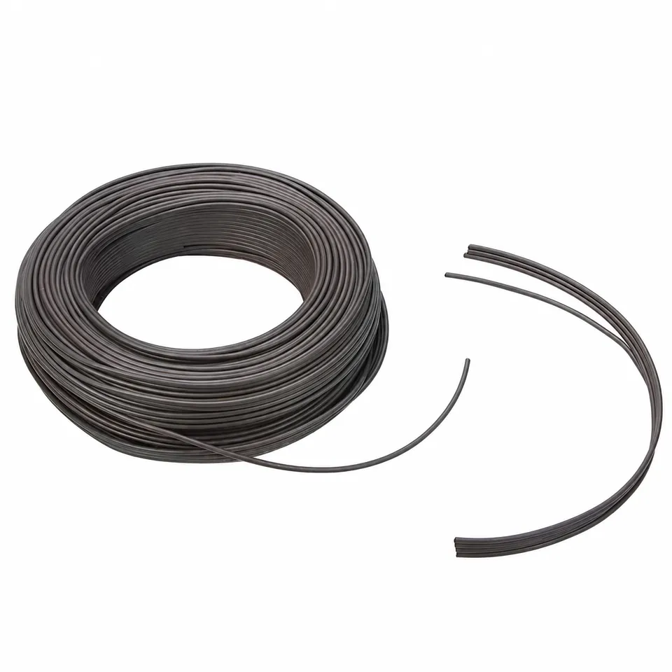 Dark magnetic cord wound into a large coil beside separate curved cut lengths.