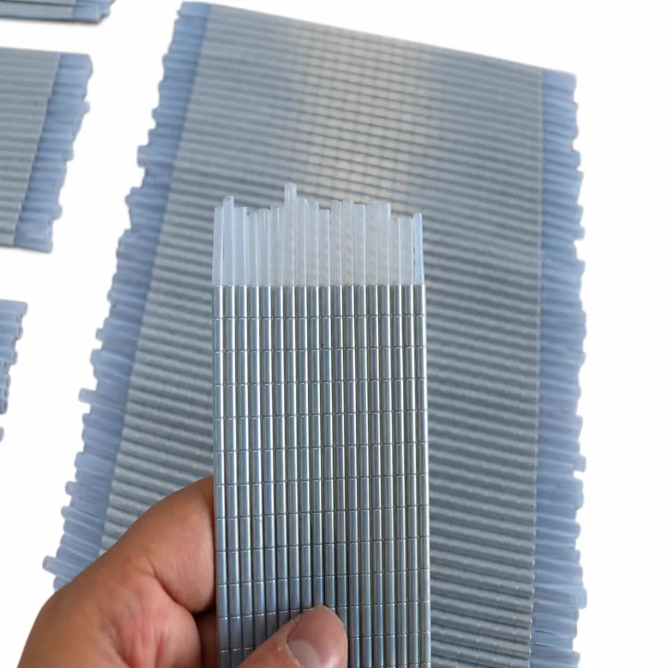 A hand holding parallel segmented magnetic cord lengths with clear sleeve tips.